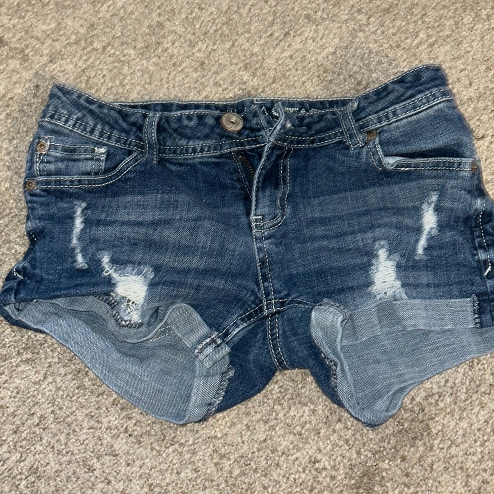 lightly ripped button up blue jean shorts